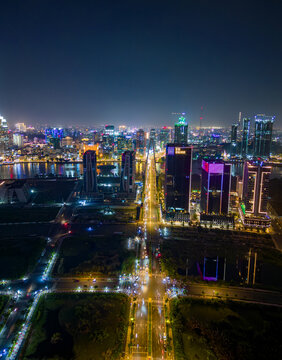 Aerial view of Ho Chi Minh City (Saigon), Vietnam, at night with glowing skyline, illuminated skyscrapers, and traffic lights reflecting on the river