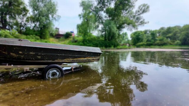 The boat is being pulled onto the lake shore