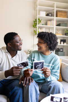 Happy holding ultrasound scan photos at home