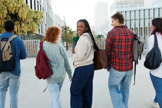 Diverse group of students walking on campus