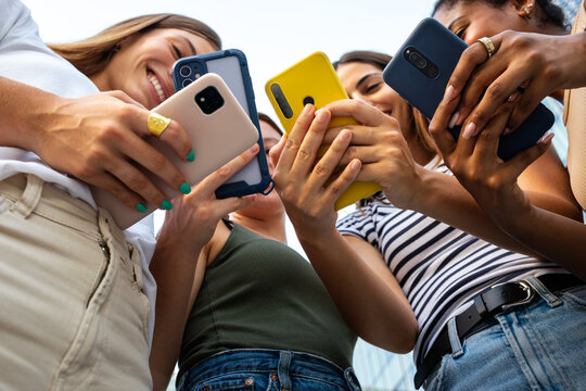 Friends sharing content on smartphones, social media connection