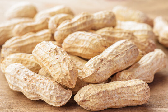 Closeup view of fresh peanuts on wooden table
