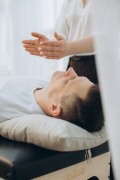 Therapist performing theta healing on client during session