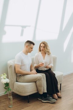 Psychologist counseling male patient during therapy session