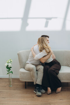 Couple embracing on sofa symbolizing support and healing