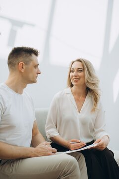 Woman psychologist smiling talking with man client