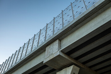 Fototapeta premium Highway bridge with concrete structure and transparent noise barrier