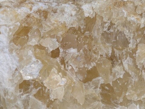 Close-up of translucent crystal formations with natural mineral texture, showcasing intricate structures and earthy tones for geology and background use.