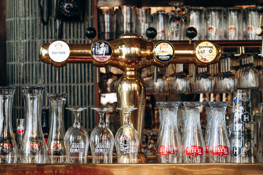 Amsterdam, Netherlands - April 20, 2026: Traditional beer taps and branded glassware inside Cafe t Smalle, a historic canal side bar in Amsterdam, Netherlands