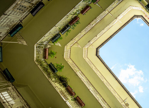 Looking skyward in the courtyard of an Art Nouveau building in Budapest's Jewish Quarter, Hungary. Elegant historic architectural detail in the style of the Hungarian Secessionist  movement. 
