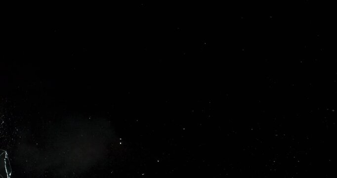 This dynamic footage of spontaneous glass breakage on a deep black backdrop is perfect for enhancing motion graphics and creating visually appealing design effects for various projects