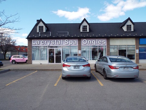 Gatineau, Quebec, Canada &ndash; May 9, 2026: The "La Crystal Spa Ongles" storefront, featuring pink and white signage, is pictured with several cars parked in front at 325 Bd Gr&eacute;ber.
