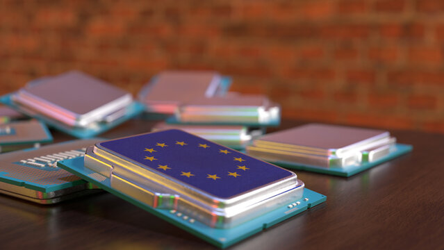 Chip with flag of European Union on a table in focus, brick wall in background