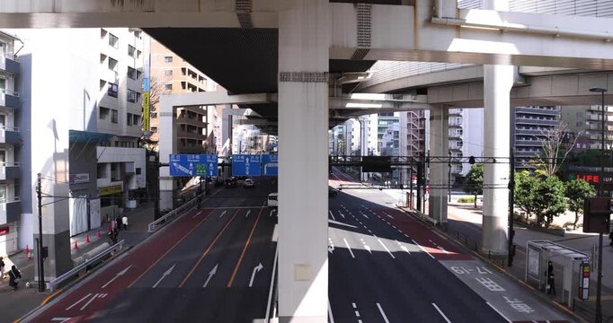 A cityscape of traffic jam at the city street under the overpass in Tokyo wide shot