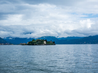 Fototapeta premium Island floats calm in vast, misty lake
