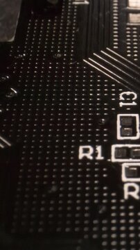 Close-up of PCB section with solder pads and R1 silkscreen