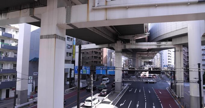 A cityscape of traffic jam at the city street under the overpass in Tokyo wide shot