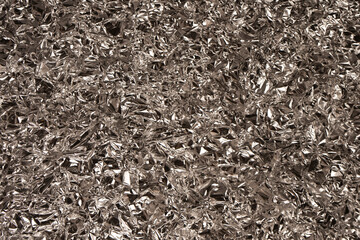 Fototapeta premium Shiny silver foil background. Top view.
