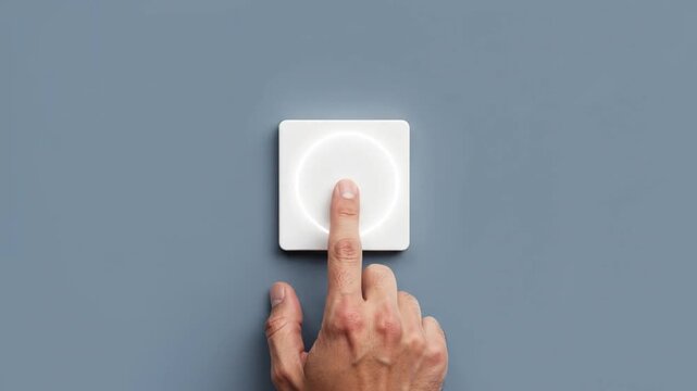A hand presses a white square touch button on a sleek grey surface, triggering glowing concentric rings that ripple outwards with each tactile interaction in this minimalist video.
