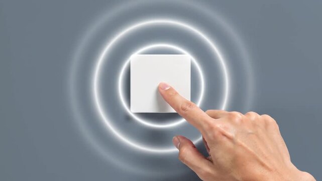 A hand presses a square white wall switch, triggering glowing concentric ripples that emanate from the button against a solid grey background, demonstrating a smart home interface.