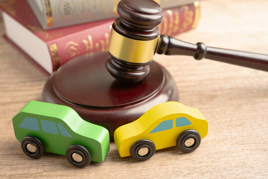 Car accident lawsuit and insurance, Judge hammer with car model.