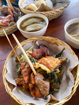 'Nasi Campur Bali' is a Balinese, Indonesian specialty consisting of steamed rice, stir-fried vegetables, roasted pork, crispy pork skin, crackers, offal and satay.
