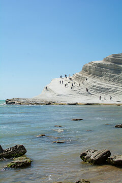 This striking photograph captures the dramatic beauty of the Stair of the Turks (Scala dei Turchi) on the coast of Realmonte, Sicily. The image reveals a vast, undulating white marl cliff face, natura