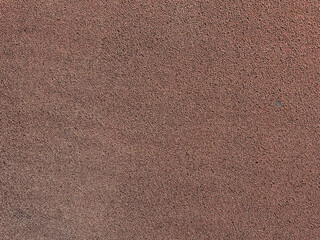 Fototapeta premium A brown surface displays fine textures of sand and minerals found in natural earth, highlighting its unique patterns