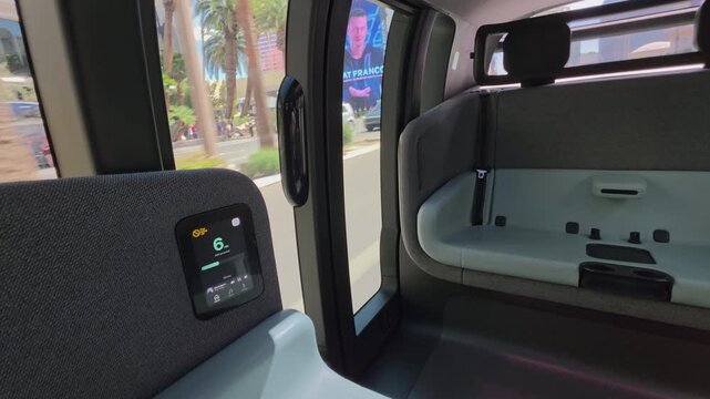 United States March 28 2026, Interior view from a Zoox autonomous vehicle driving through Las Vegas with smart display and passenger seats