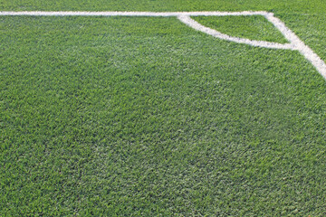 Fototapeta premium close up photo of soccer field corner showing grass texture white lines and stadium pitch detail in outdoor sports environment