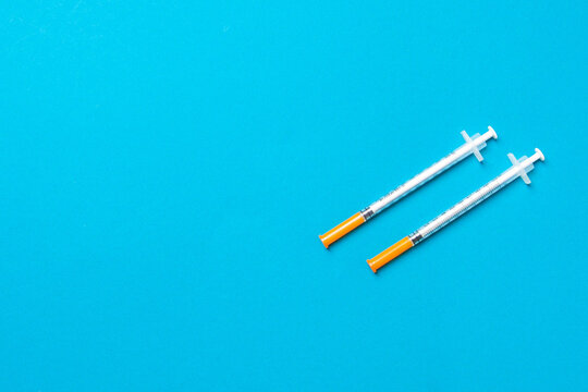 Top view of insulin syringes ready for injection on colorful background. Diabetic concept with copy space