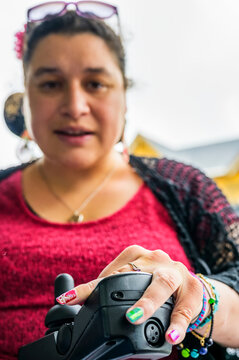 Maori woman with Cerebral Palsy in a wheelchair, fingernails showing nail art