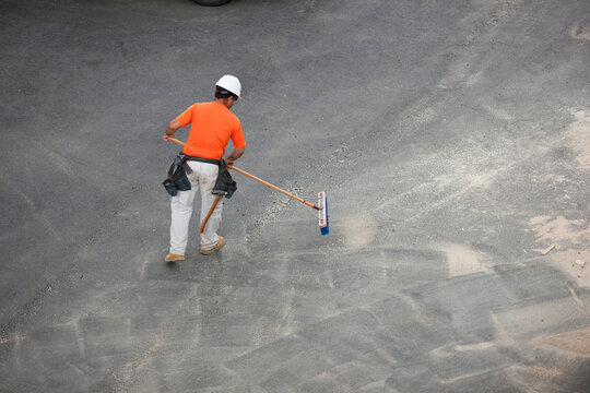 Carpenter sweeping up after building
