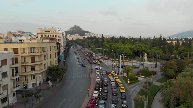Aerial drone video of  Plaka district, Lycabettus Hill, Vasilissis Amalias Avenue in Athens, near Acropolis and Parthenon Acropolis hill, Plaka picturesque district below, Athens historic centre, Atti