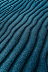 Fototapeta premium Abstract Blue Sand Ripples And Textured Dune Pattern Closeup Showing Wind-Sculpted Lines And Calm