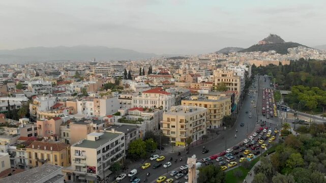 Aerial drone video of  Plaka district, Lycabettus Hill, Vasilissis Amalias Avenue in Athens, near Acropolis and Parthenon Acropolis hill, Plaka picturesque district below, Athens historic centre, Atti