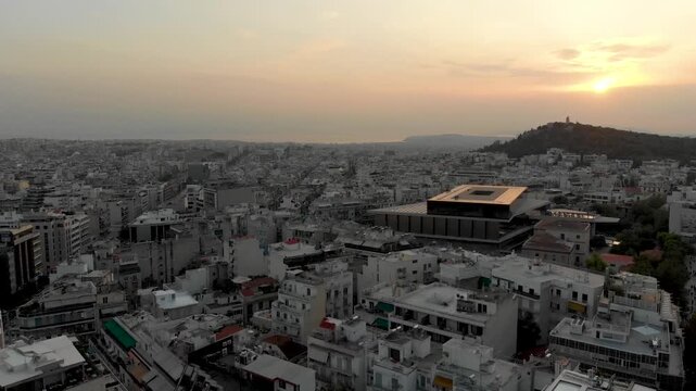 Aerial drone video of  Plaka district, Lycabettus Hill, Vasilissis Amalias Avenue in Athens, near Acropolis and Parthenon Acropolis hill, Plaka picturesque district below, Athens historic centre, Atti