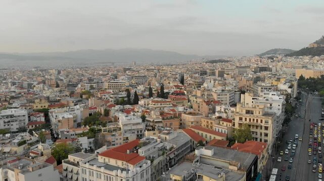 Aerial drone video of  Plaka district, Lycabettus Hill, Vasilissis Amalias Avenue in Athens, near Acropolis and Parthenon Acropolis hill, Plaka picturesque district below, Athens historic centre, Atti