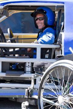 Smiling male disability auto racer