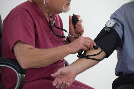 Doctor measuring patient's blood pressure
