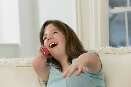 Teenage girl with birth defect talking on a mobile phone