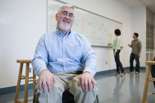University professor with Muscular Dystrophy in a classroom