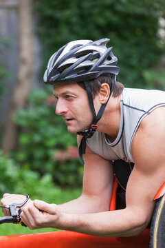 Man with spinal cord injury in disability racing bike