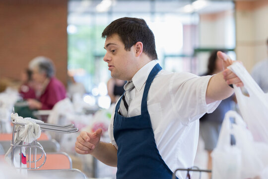 Man with Down Syndrome working at a grocery store