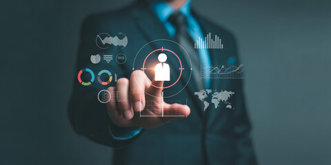 Fototapeta premium Businessman working with virtual screen and analyzing sales data. target customer concept. business global internet connection application technology and digital marketing.