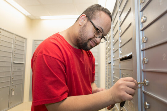 African American man with Down Syndrome checking his mailbox