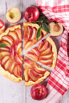rustic nectarine tart slices with fresh fruits on wooden table