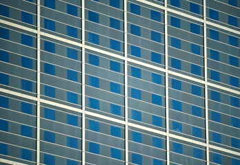 Cityscape with scenic exterior view of a high-rise building facade with symmetrical blue windows  © ELENI MAVRANDONI
