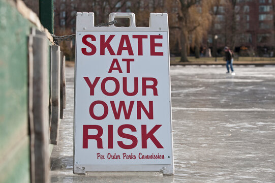 'Skate at Your Own Risk' warning sign in a public garden
