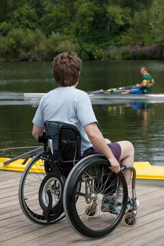 Woman with spinal cord injury sitting in a wheelchair on the dock